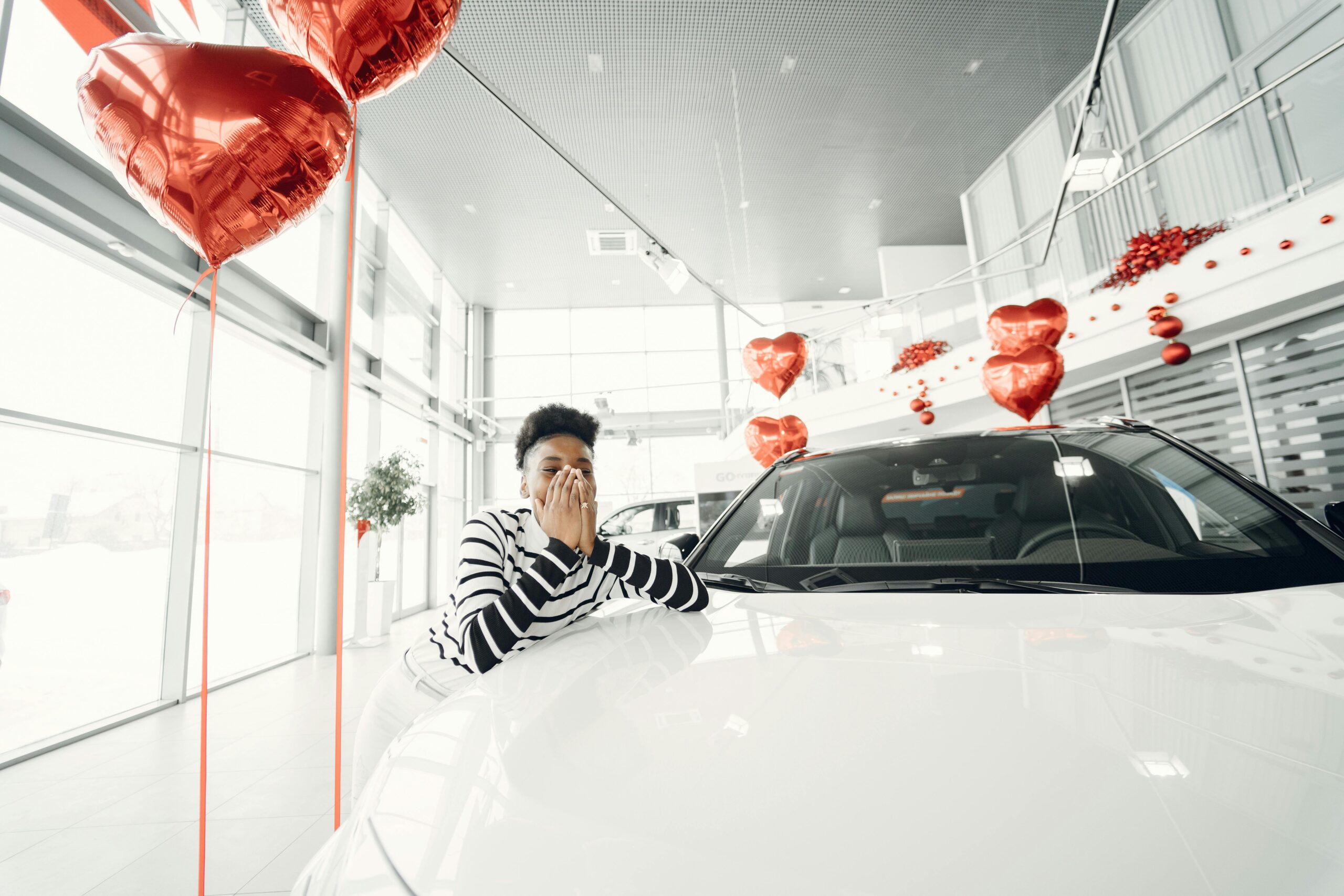 Photo by Gustavo Fring: https://www.pexels.com/photo/young-woman-leaning-on-a-new-car-at-car-dealership-6817021/