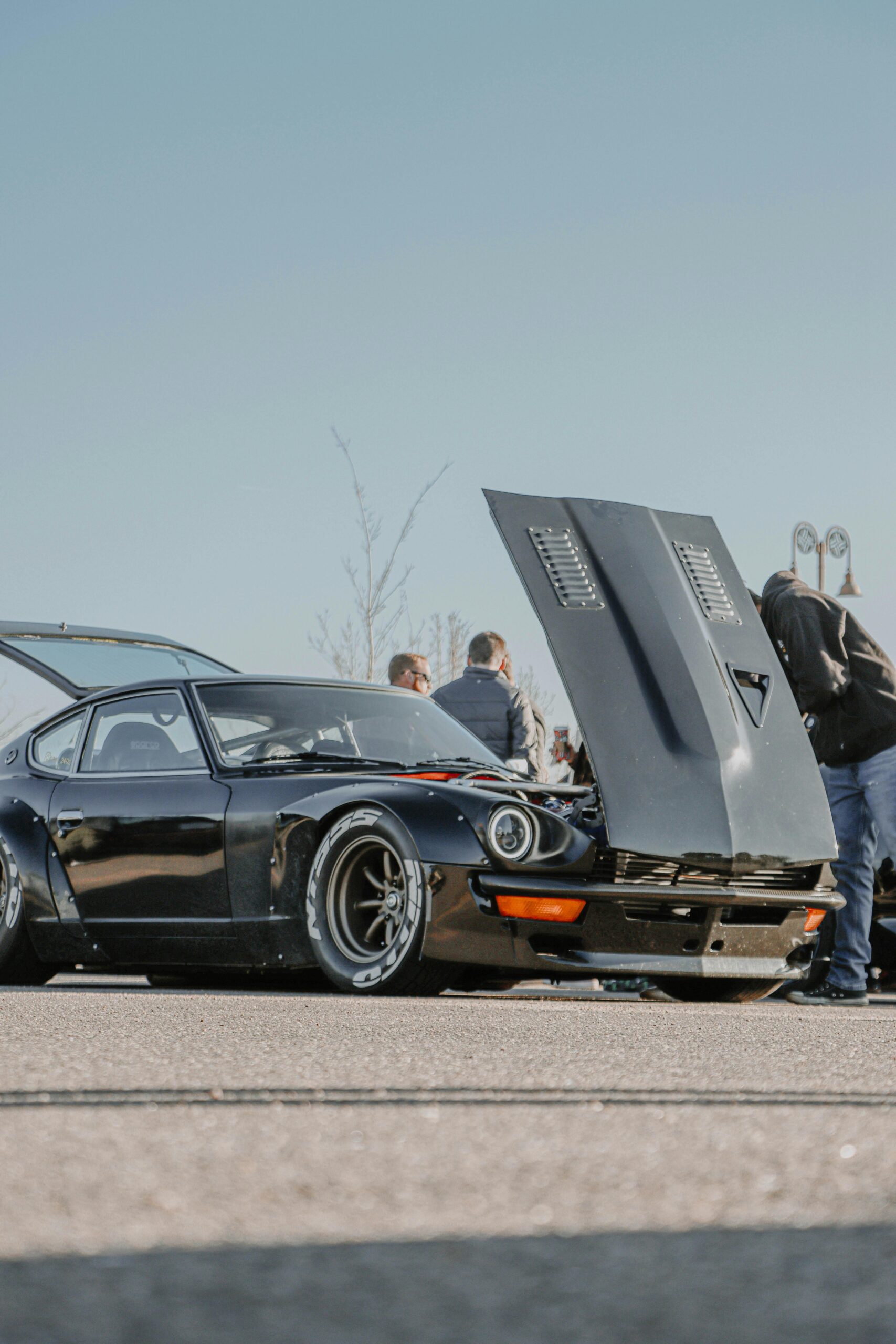 Photo by Jacob Moore: https://www.pexels.com/photo/nissan-fairlady-z-with-a-raised-hood-parked-on-a-parking-lot-at-a-car-meet-11546084/