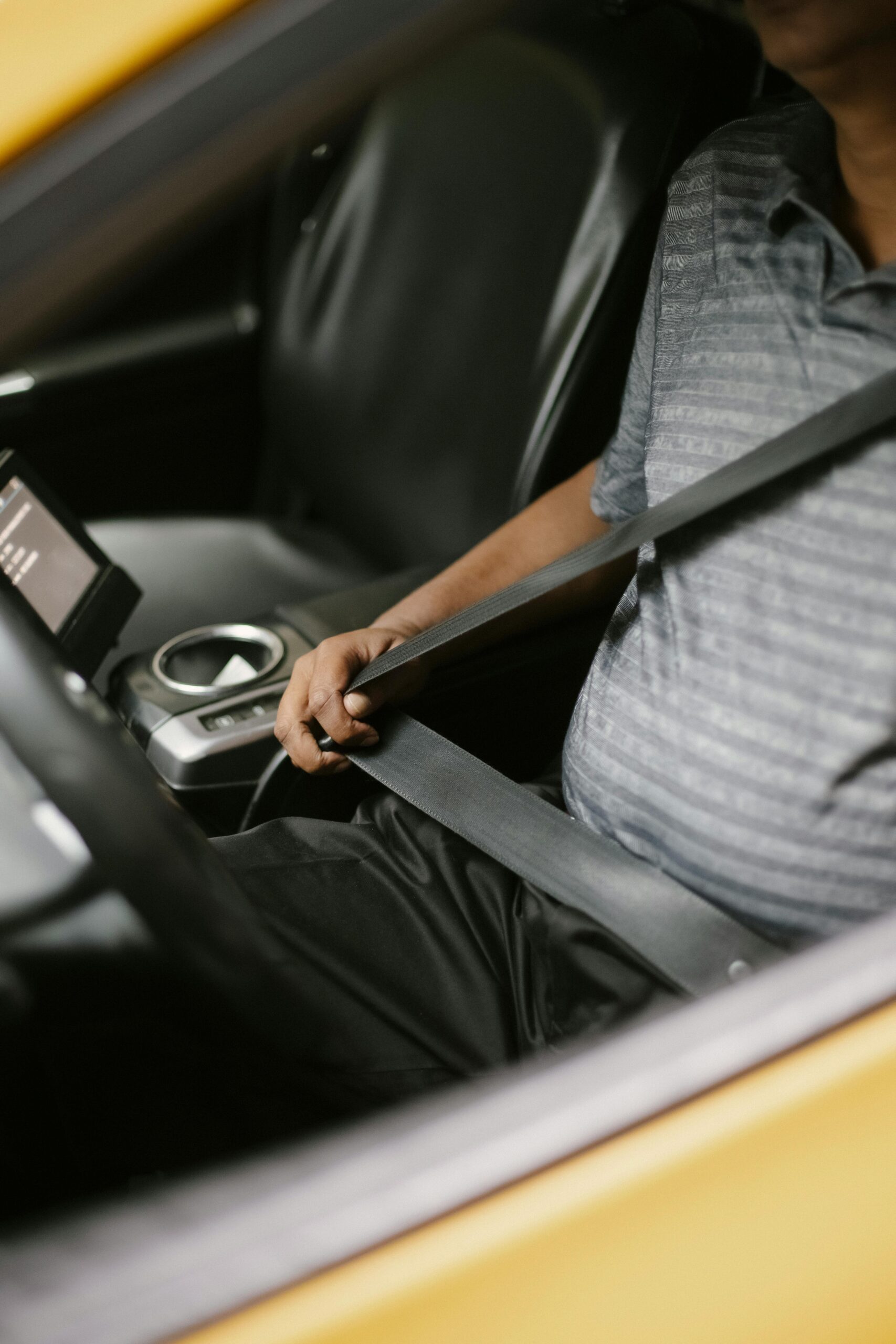 Photo by Tim Samuel: https://www.pexels.com/photo/anonymous-man-fastening-seat-belt-in-vehicle-5834960/